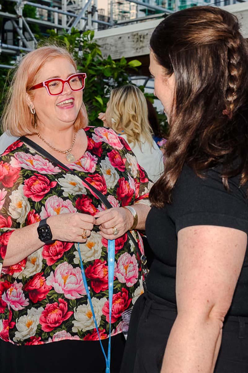 women talking at an event